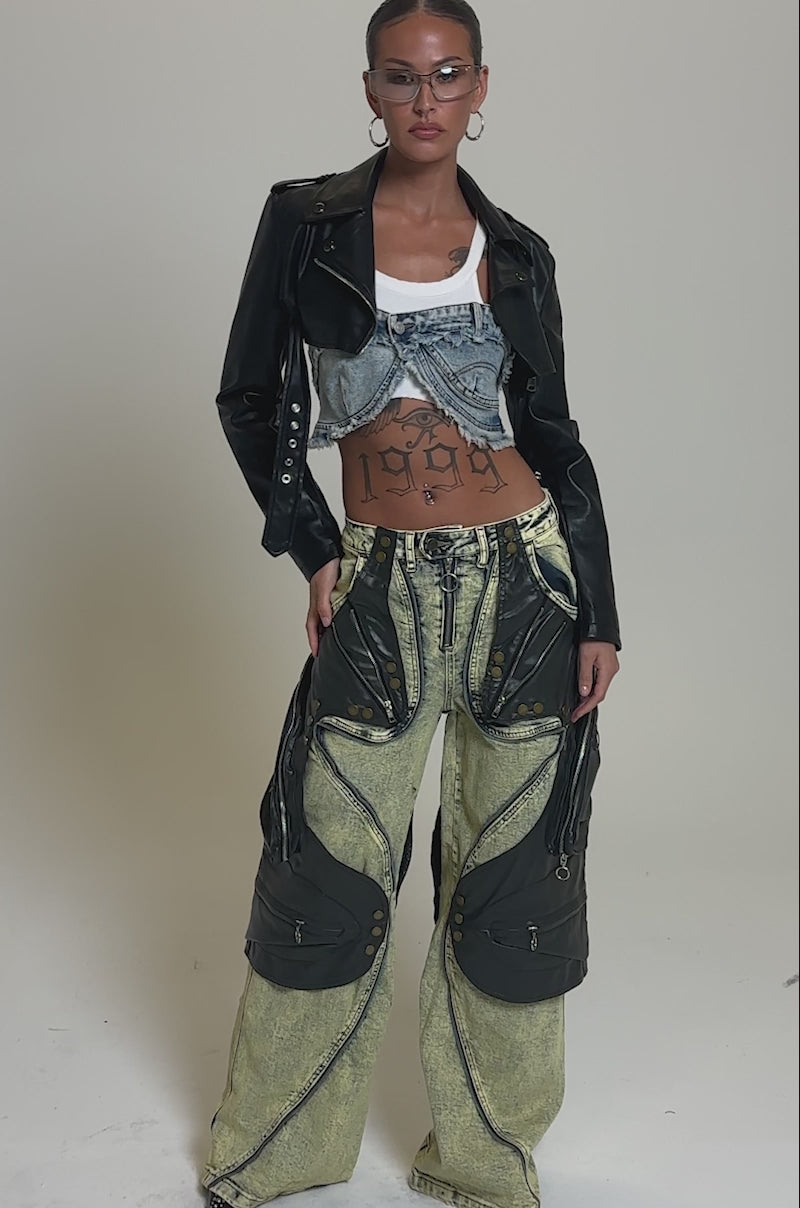 Video of woman modeling the CRAZY FOR YOU RELAXED DENIM, paired with a black leather jacket, distressed cropped denim top, hoop earrings, sunglasses, and midriff tattoos