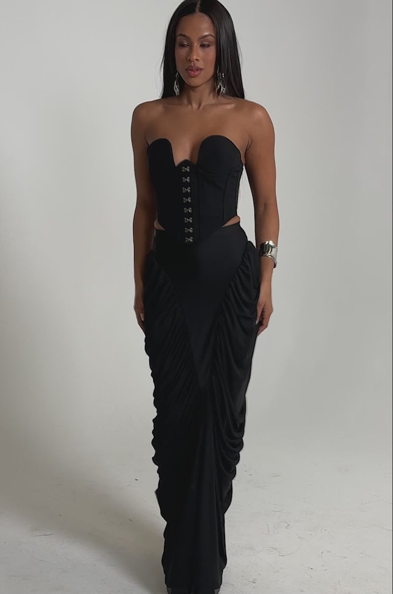 A video of a woman in a strapless black corset top and the DREAMY RUCHED SKIRT featuring a high-rise waistband. 