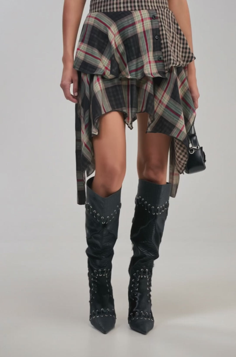 Video of a woman modeling the MIXED EMOTIONS PLAID MINI SKIRT with its asymmetrical cut.