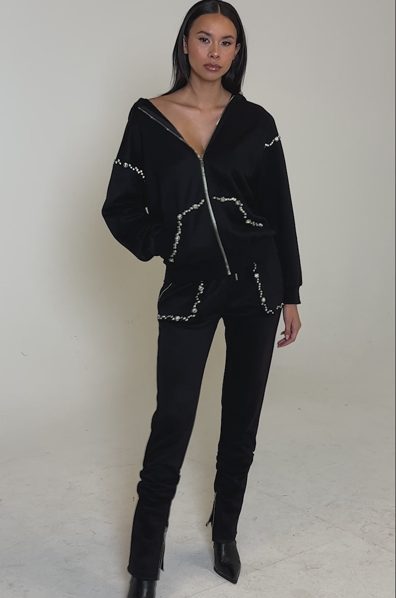 Video of woman modeling the COZY HOLIDAY RHINESTONE ZIP UP SWEATSHIRT IN BLACK, paired with matching pants featuring rhinestone details
