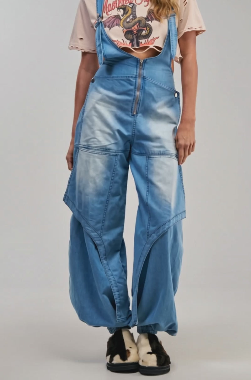 Video of a woman modeling the OUT TO PLAY DENIM OVERALL JUMPSUIT.