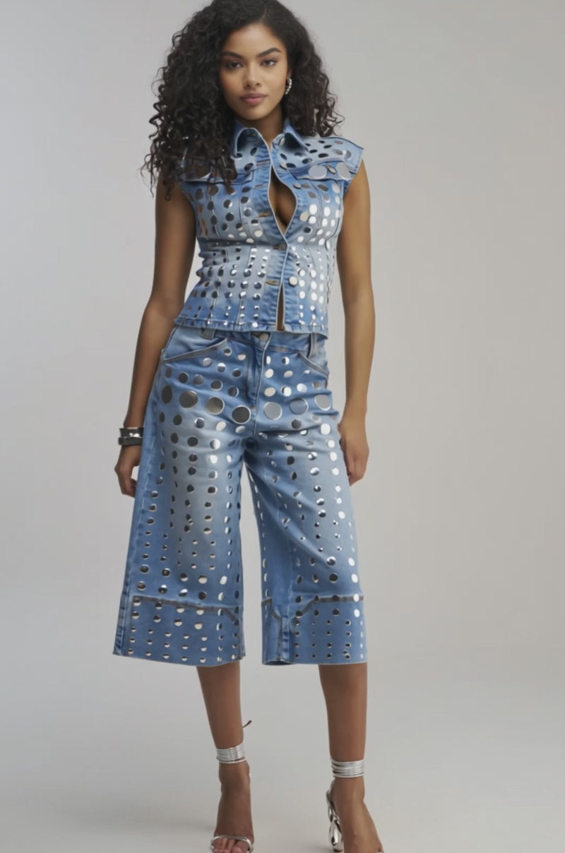 Video of woman modeling the STUDS EVERYWHERE BUTTON DOWN, featuring metallic studs and shiny silver circles that catch the light, paired seamlessly with matching jeans for a standout concert-ready look. 