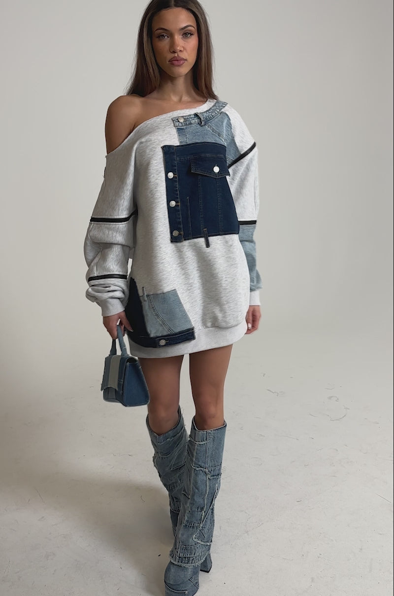 Video of woman modeling the ADIRA MINI SWEATER DRESS with denim patchwork, styled with matching denim boots and a small denim handbag. 