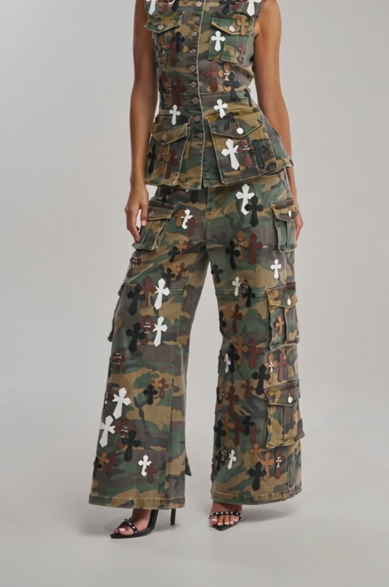 Video of woman modeling the DOWN AND DIRTY CAMO CARGO PANT—sleeveless camo vest and matching wide-leg pants with white and brown crosses