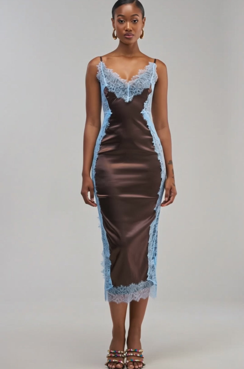 Video of a woman modelling the ESSENTIAL LACE TRIM SATIN SLEEVELESS MAXI DRESS IN BROWN—a fitted chocolate satin dress featuring light blue lace trim, thin straps, and a V-neckline.