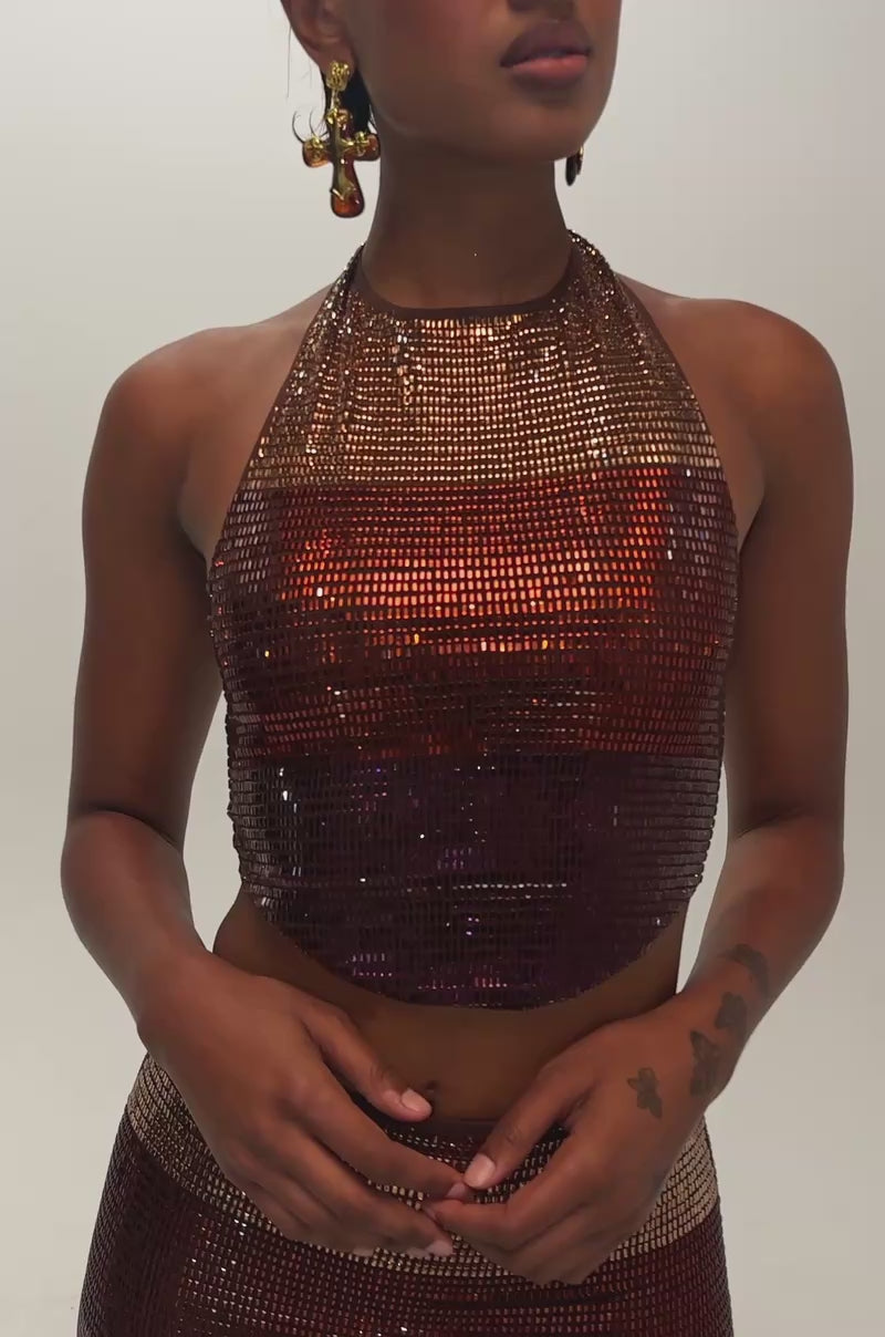 Video of a woman modeling the SHINE BRIGHT RHINESTONE TOP, a sleeveless metallic halter.