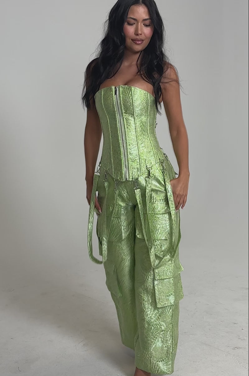 Video of woman modeling the ENVY ME BROCADE PANT—high-waisted, light green shimmer cargo pants with large pockets