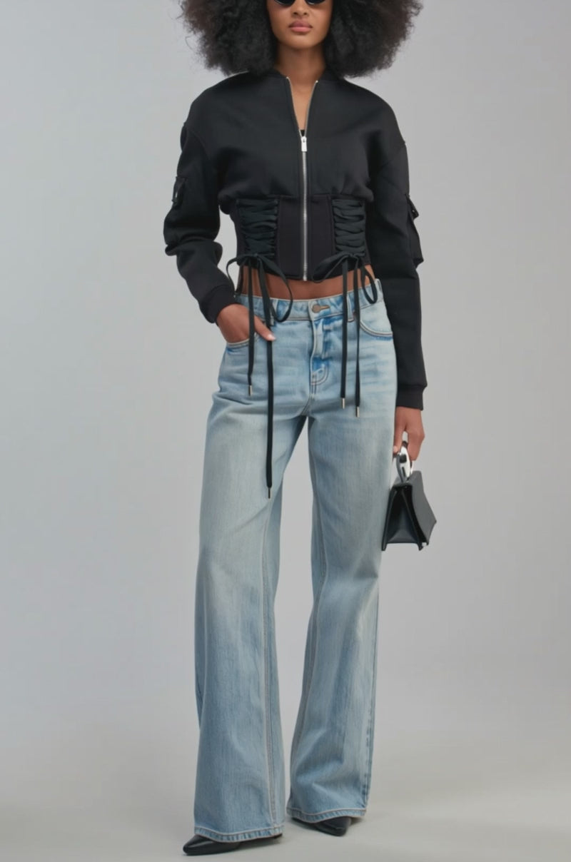 Video of  woman modeling the VIVIENNE FITTED BOMBER—a streetwear-inspired black jacket with lace-up details.