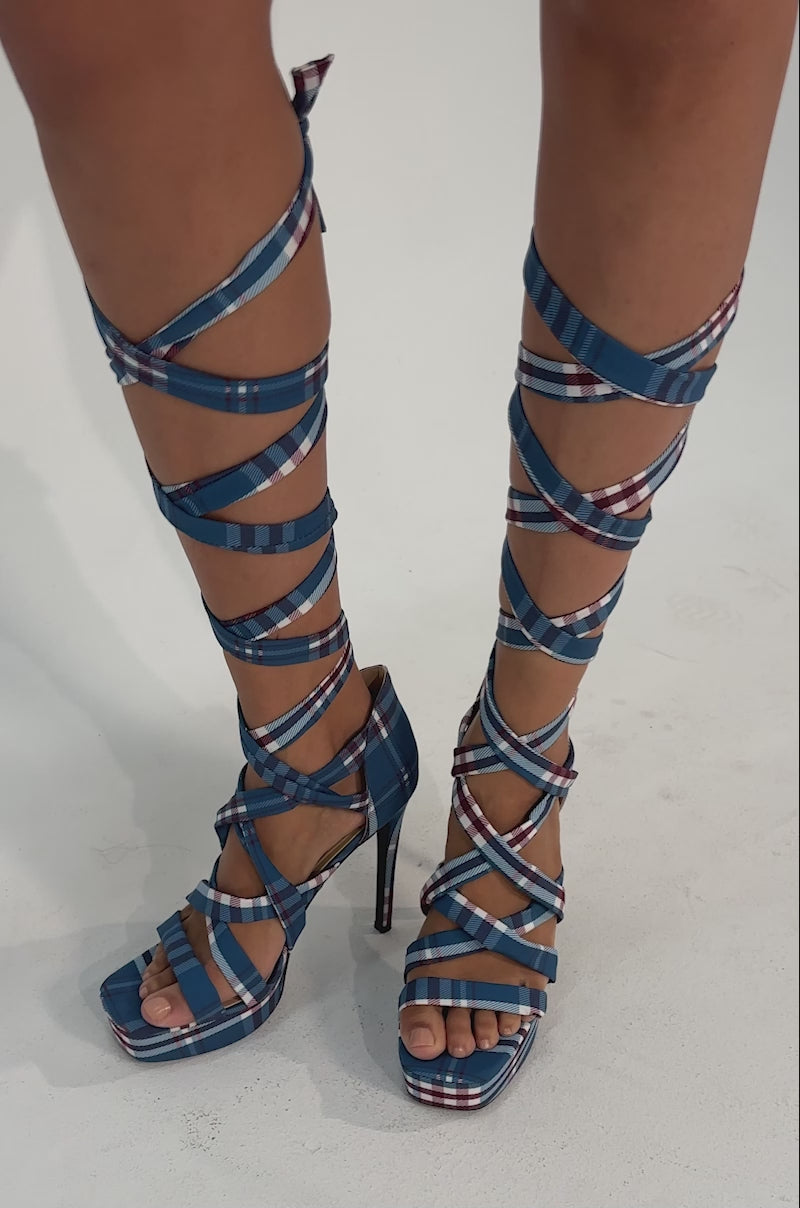 A video of a person wearing the AZALEA WANG JEMISHA BLUE PLAID PRINT PLATFORM STRAPPY SANDAL.