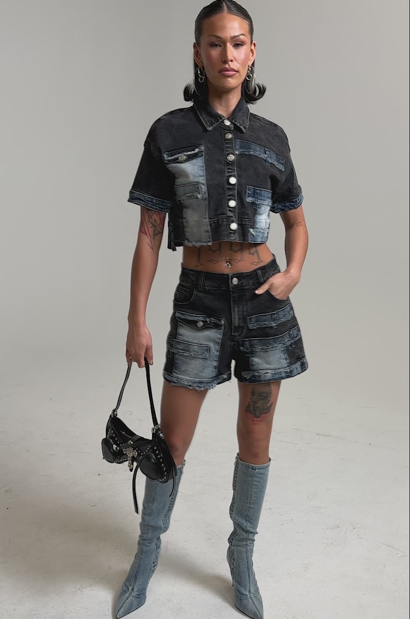 A video of a woman wearing the RAJ DENIM BUTTON DOWN and high-waisted patchwork shorts.
