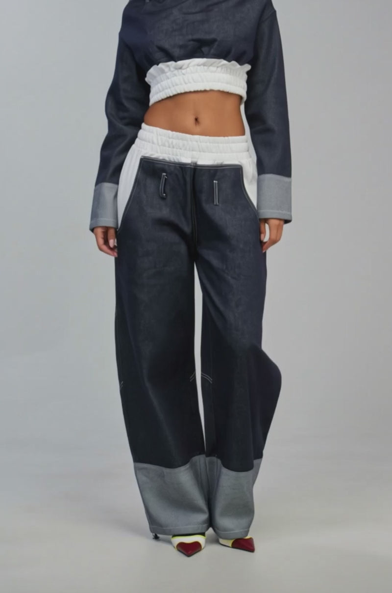 Video of a woman modeling the WHO SHE WIDE LEG JOGGER in dark denim.
