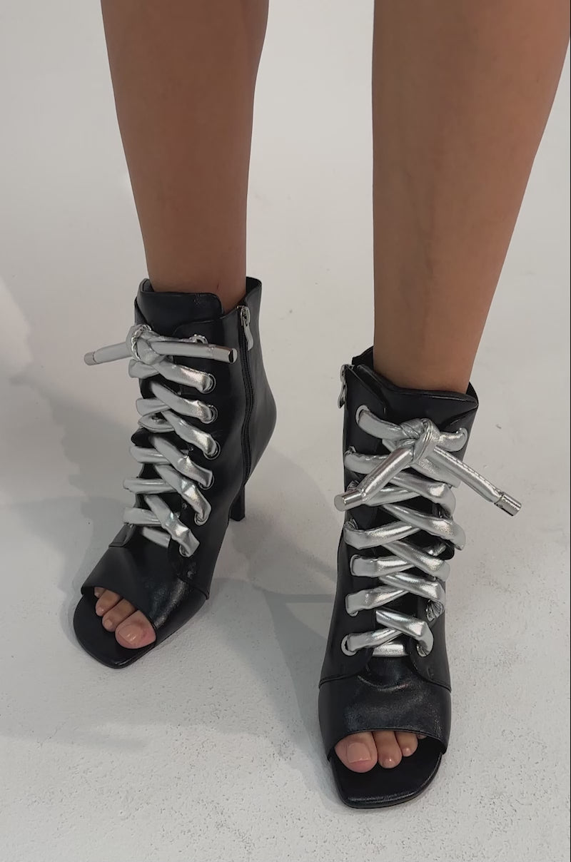 A video of a person wearing the AZALEA WANG JOSS BLACK BLOCK LACE OPEN TOE BOOTIE.