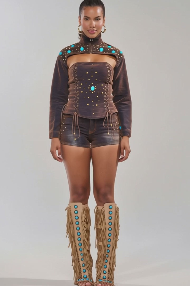 Video of woman modeling the INDIGO STUDDED DENIM BOLERO over a brown off-shoulder top and shorts with turquoise stones and gold studs
