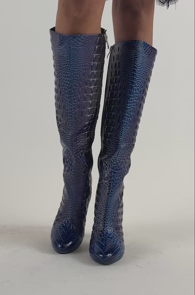 Video of a woman modeling the AZALEA WANG MARGAERY MULTI CROC BLOCK BOOT—a striking pair of purple blue ombre block-heel boots.