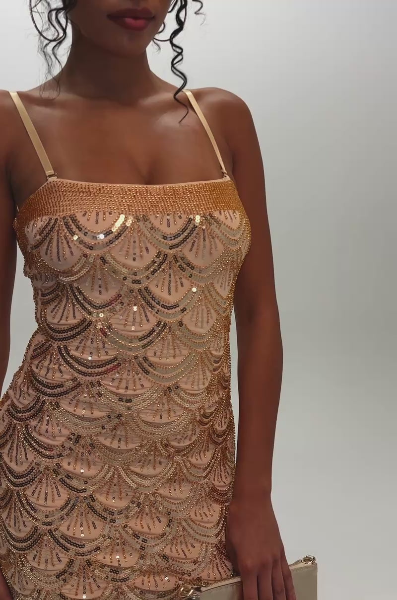 Video of a woman modeling the COCKTAIL HOUR SEQUIN MINI DRESS IN GOLD, a glamorous bodycon mini dress featuring scalloped sequin patterns.