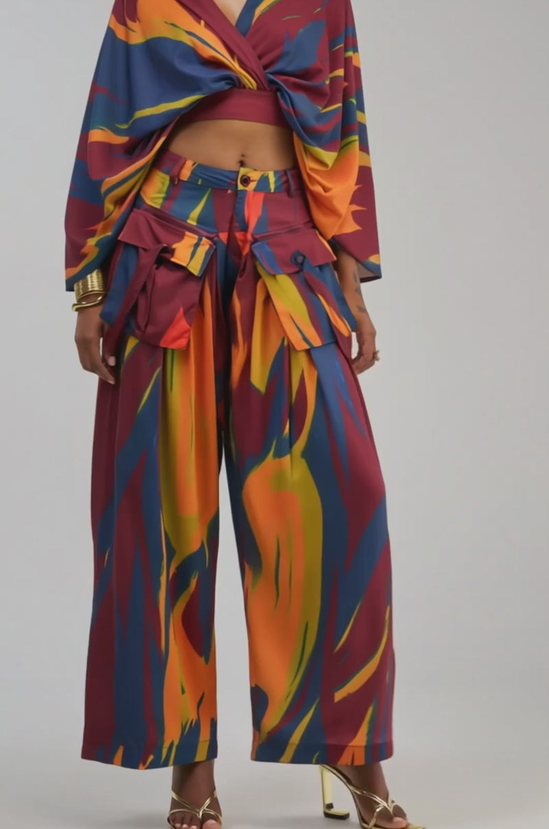 Video of a woman modeling the TAKE ME AWAY BLOUSE, featuring a vibrant, abstract print and wide sleeves.