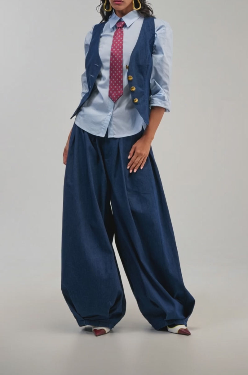 Video of a woman modeling the BUSINESS IN THE FRONT BUTTON DOWN—a light blue button-down shirt.