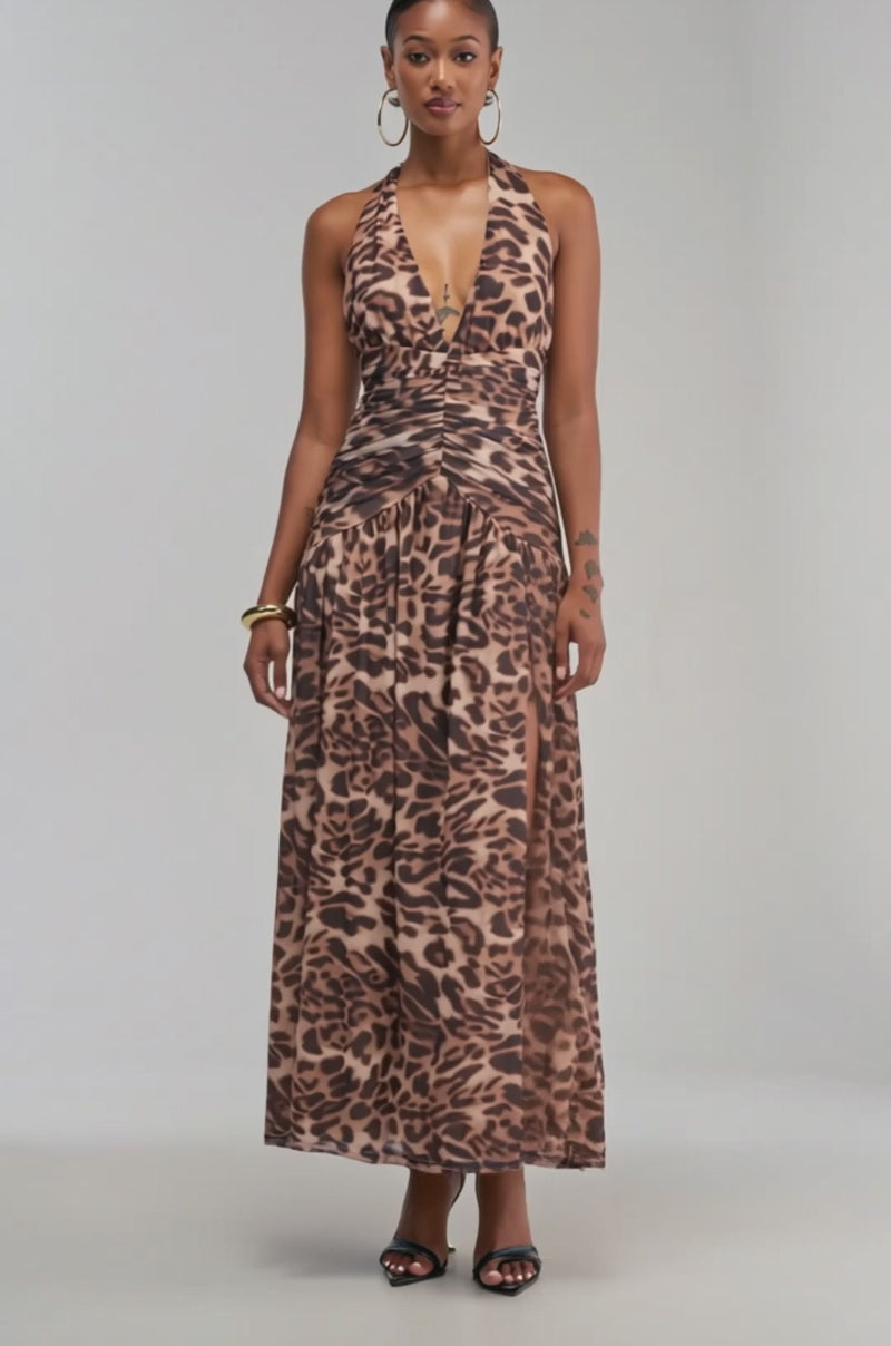 Video of a woman modeling the SUGAR RUSH Mesh Maxi Dress in Animal, a sleeveless halter dress featuring a striking brown and black cheetah print.