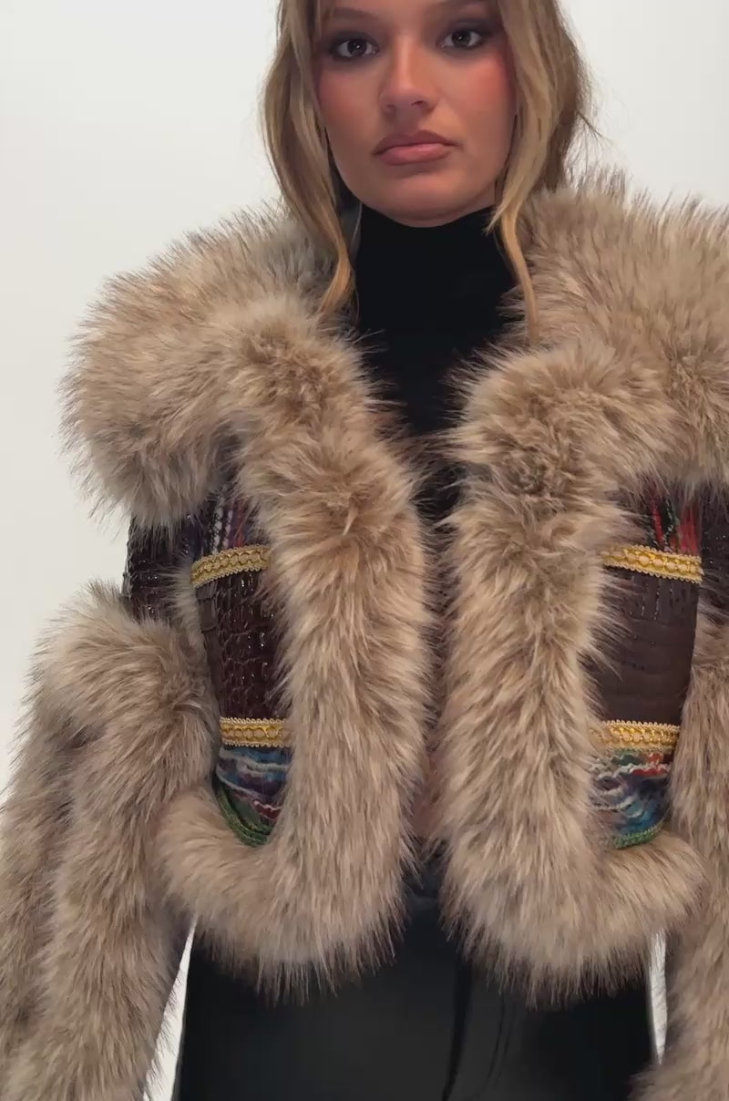 Video of a woman modeling the DRIFTER PATCHWORK FAUX FUR jacket, featuring colorful accents and faux fur trim.