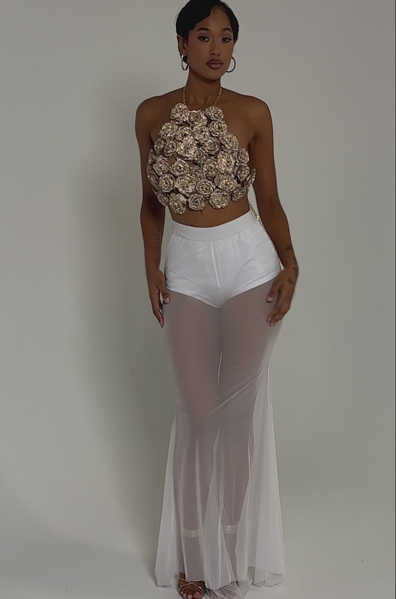 Video of woman modeling the DANCING QUEEN MESH MAXI SKIRT IN WHITE, styled with a sleeveless crop top and white undergarments—an effortlessly confident look ideal for layered evening ensembles.