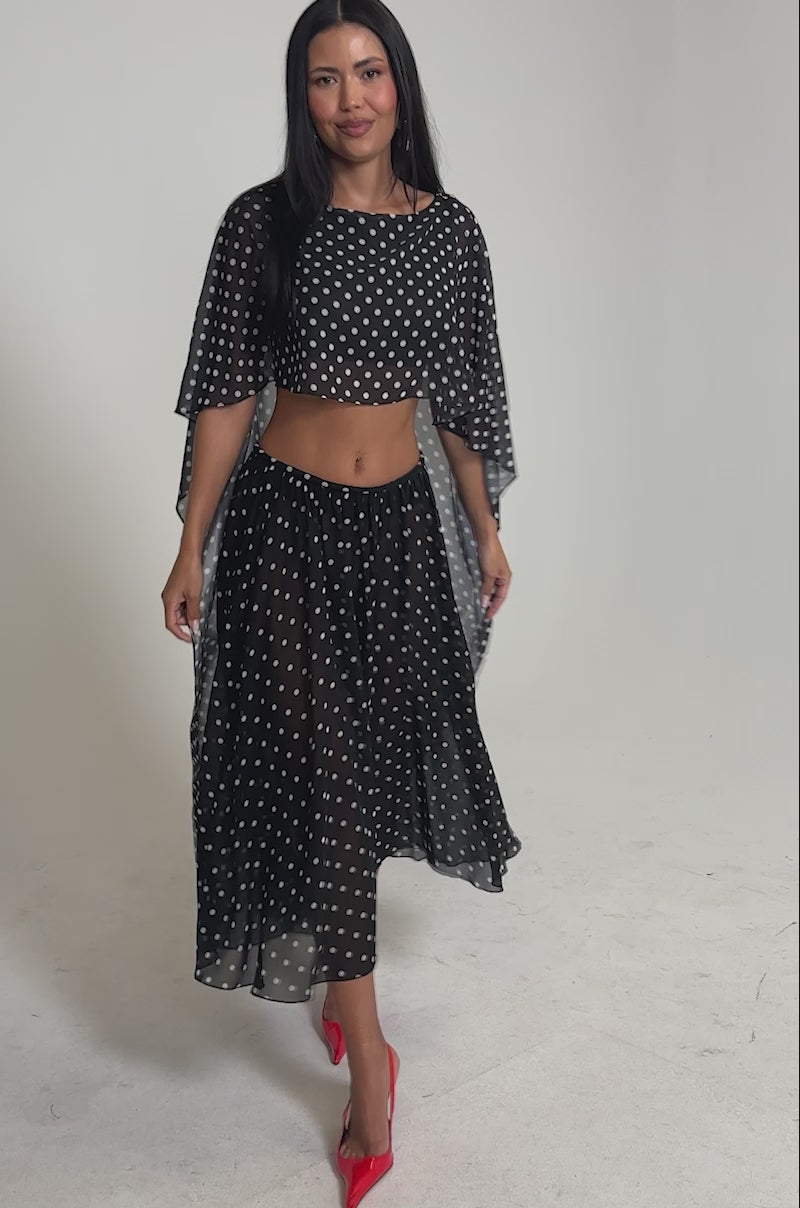 Video of woman modeling the COOL GIRL POLKA DOT GAUCHO PANT in sheer black, paired with bright red pointed heels