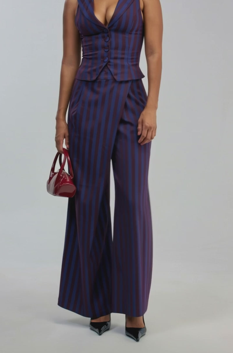 Video of a woman modeling the MANHATTAN ASYMMETRICAL STRIPE TROUSER—wide-leg pants featuring an asymmetrical blue and purple stripe design.