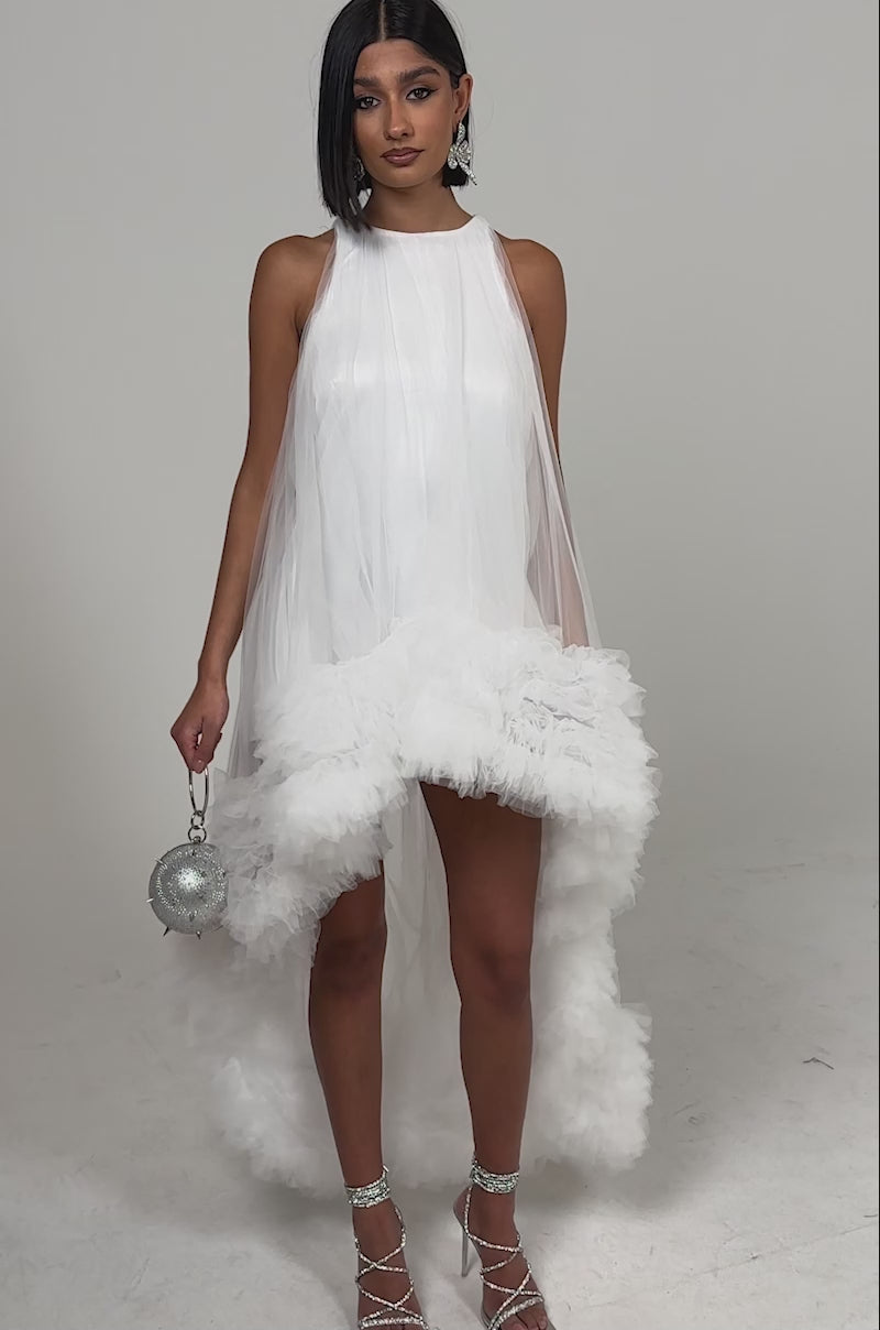 A video of a woman in the ARI TULLE RUFFLE HIGH LOW MINI DRESS IN WHITE.