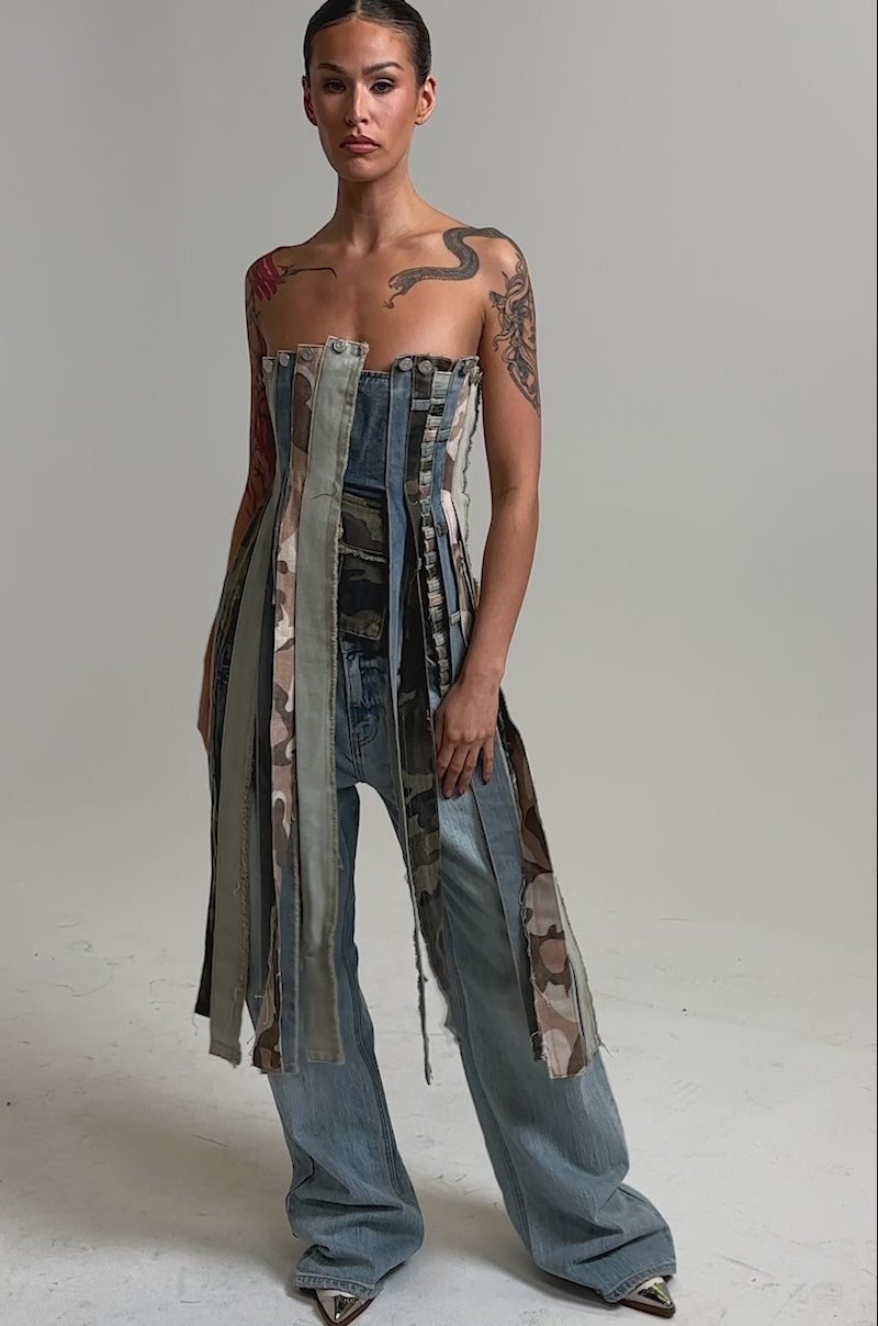 Video of woman modeling the MIXED EMOTION CORSET—a mixed-denim, vertically striped corset top—paired with light blue jeans.