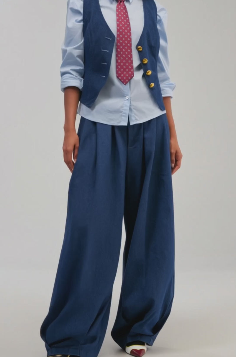 Video of a woman modeling the BUSINESS IN THE FRONT VEST layered over a light blue shirt.