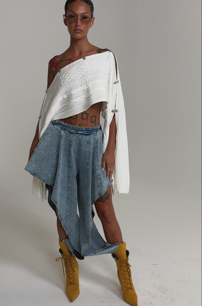 A video of a woman wearing the COOLEST EVER DENIM high-rise jeans with asymmetrical layered panels.