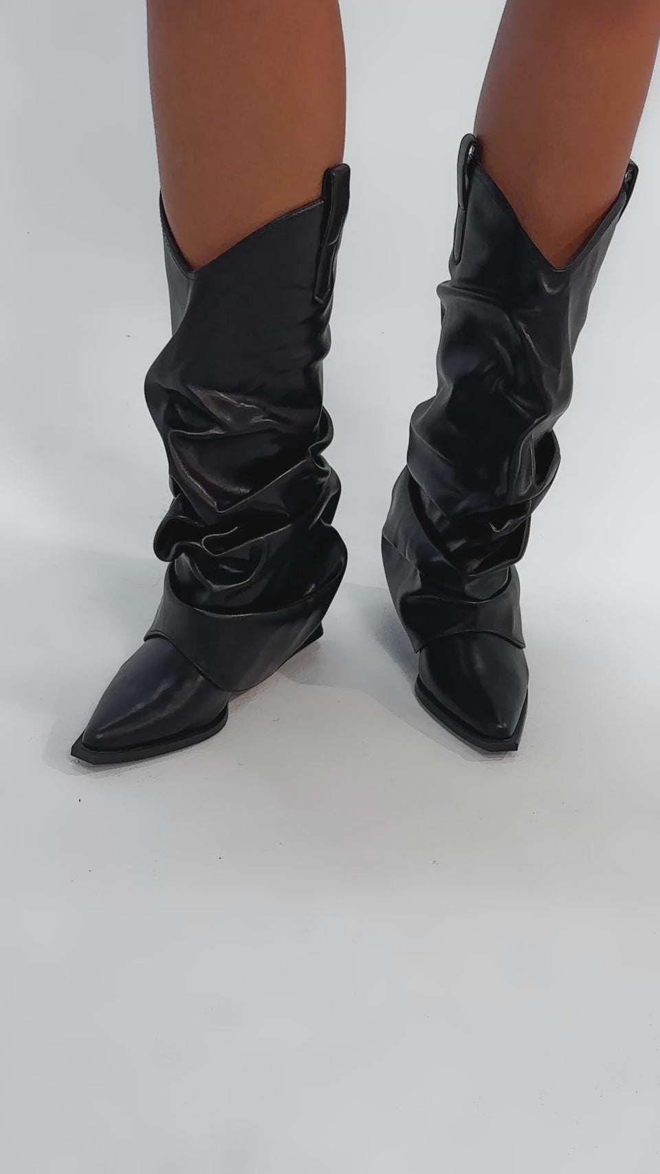 Video of woman modeling the AZALEA WANG HAWKSTON BLACK PU RUCHED WESTERN BOOTIE, featuring a ruched mid-calf design, pointed toes, and angled heels