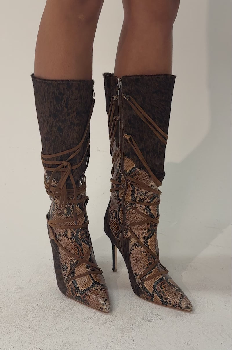 A video of a person wearing the AZALEA WANG SHERYL BROWN COW AND SNAKE STILETTO BOOT.