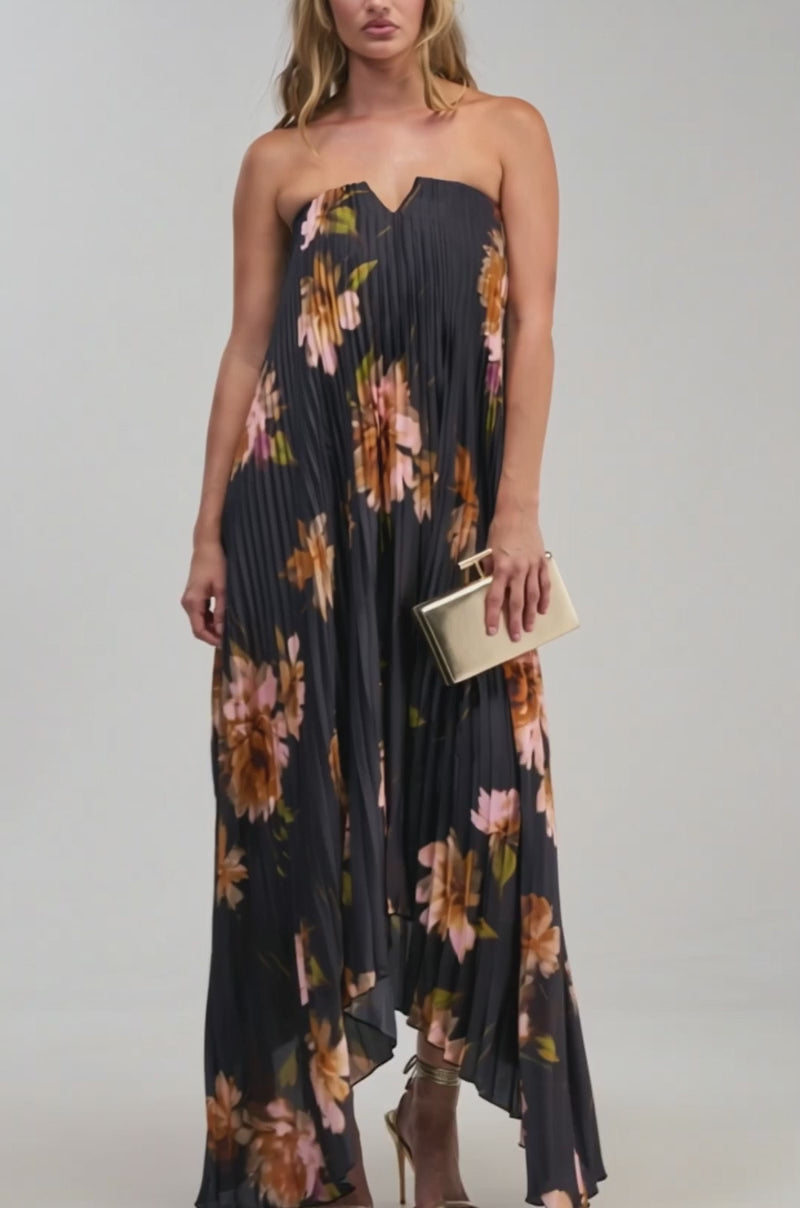 Video of a woman modeling the MEET ME IN ITALY SATIN MIDI DRESS IN BLACK MULTI, a strapless black dress featuring a pink and orange floral print and pleated silhouette.