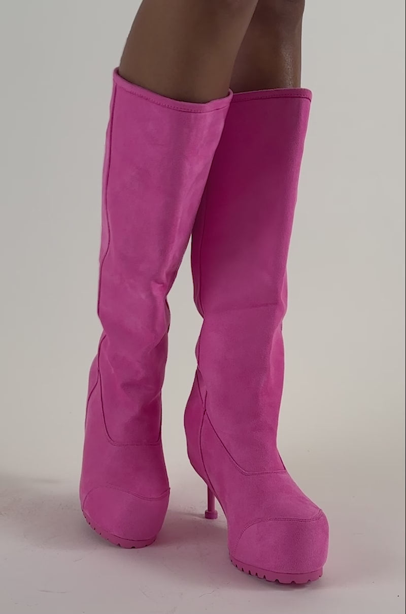 Video of a woman modeling the AZALEA WANG CLEDQYN Pink Suede Stiletto Boot, styled with knee-high, bubblegum pink platforms featuring tall heels.