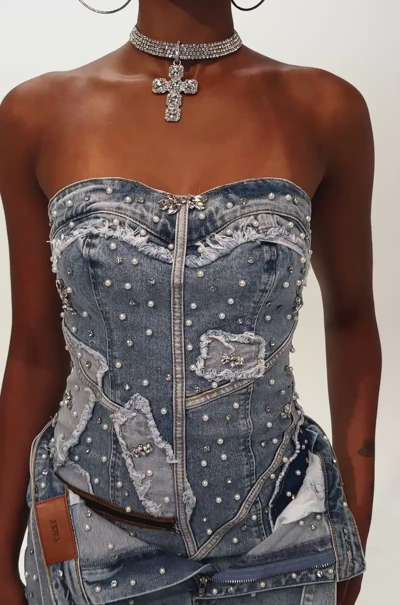 Video of woman modeling the THIS IS MY CALLING EMBELLISHED DENIM MINI DRESS—strapless, adorned with pearls and zippers