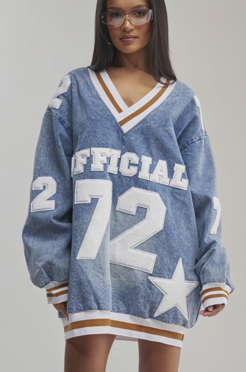 Video of a woman modeling the  PLAYER FOR YOU DENIM JERSEY MINI DRESS with “OFFICIAL 72” in bold white letters.