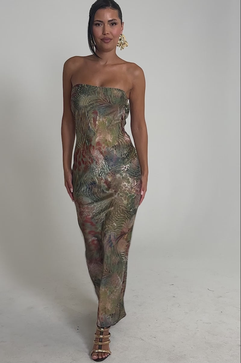 Video of woman modeling the IT GIRL SATIN MAXI DRESS, featuring a strapless, vibrant tropical print. She accessorizes with large hoop earrings and strappy high-heeled sandals