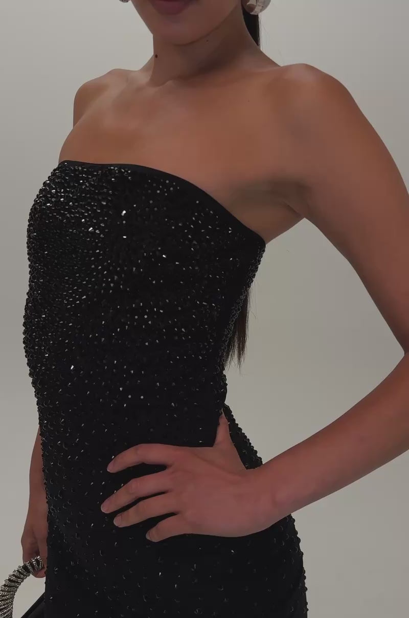 Video of a woman modeling the CALL IT CHEMISTRY RHINESTONE MINI DRESS IN BLACK—a fitted, strapless mini adorned with rhinestones.