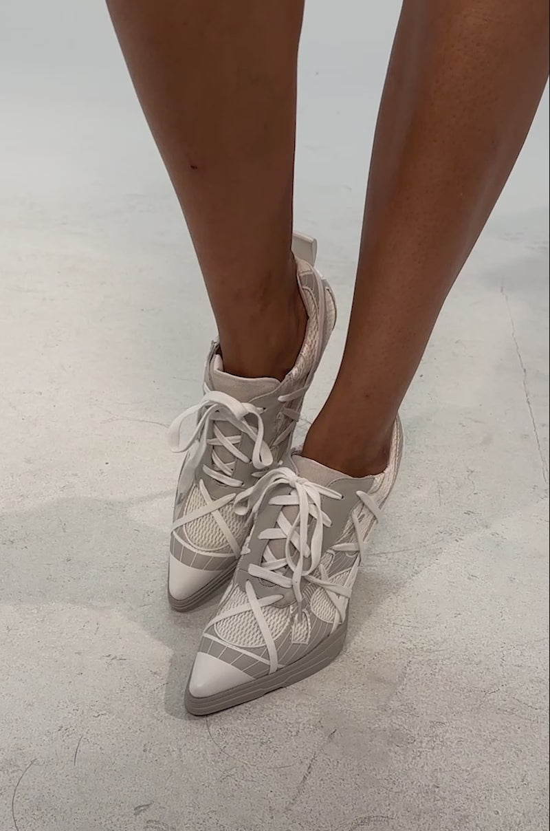 Video of woman modeling the AZALEA WANG CROSS WALK LIGHT GREY STILETTO SNEAKER HEEL with platform rubber outsole, set against a neutral background.