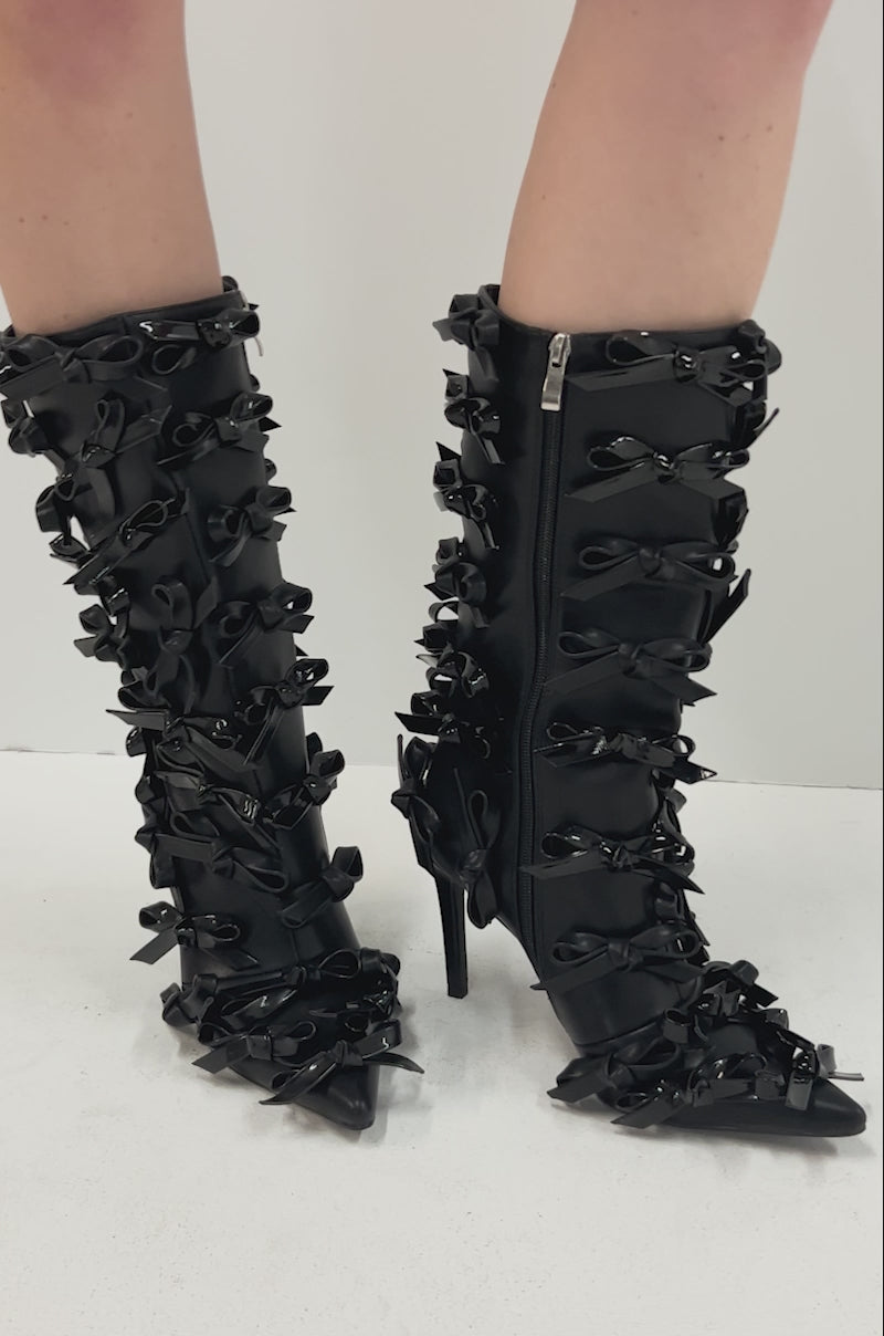 Video of person modeling the AZALEA WANG TELMO BLACK BOW EMBELLISHED BOOTIE, featuring stiletto heels accented with multiple bows