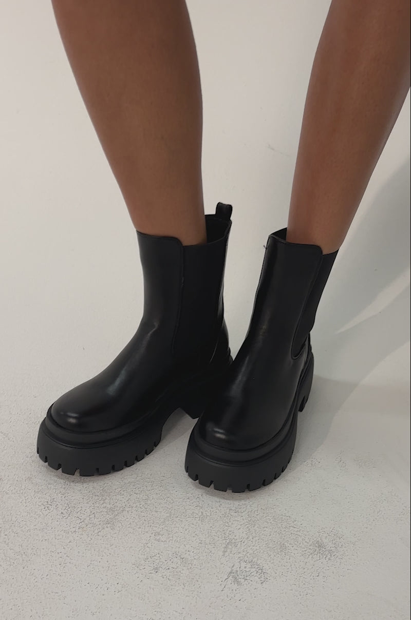 Video of woman modeling the AZALEA WANG RAMPAGE Black Distressed Two Piece Combat Boot 