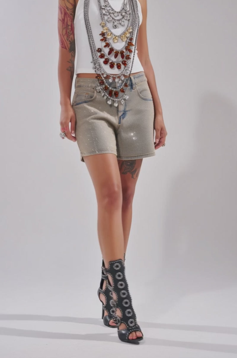 Video of woman modeling the CHECK IT OUT EMBELLISHED RHINESTONE TOP, paired with faded jean shorts