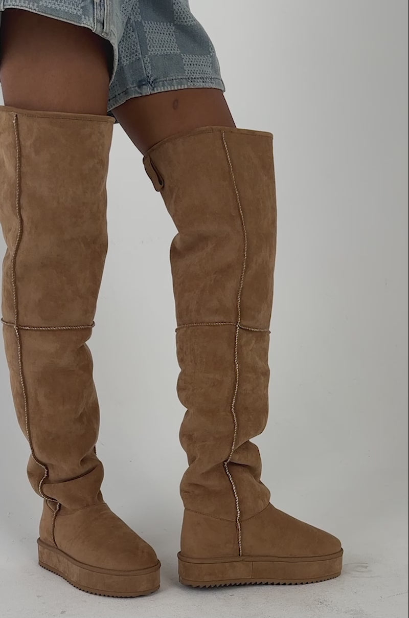 Video of a woman modeling the  AZALEA WANG MARLOW CHESTNUT FAUX SUEDE SHERLING OVER THE KNEE PLATFORM BOOT, shown from waist to feet.