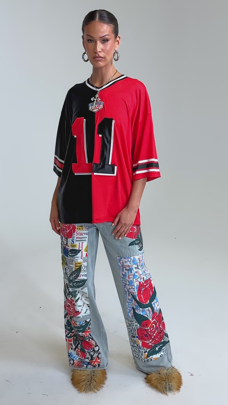 Video of woman modeling the CIAO BELLA STRIPE TROUSER, striped denim wide-leg pants adorned with colorful patches of red roses, text, and graphics, styled with fuzzy tan shoes and a partly visible cropped top.