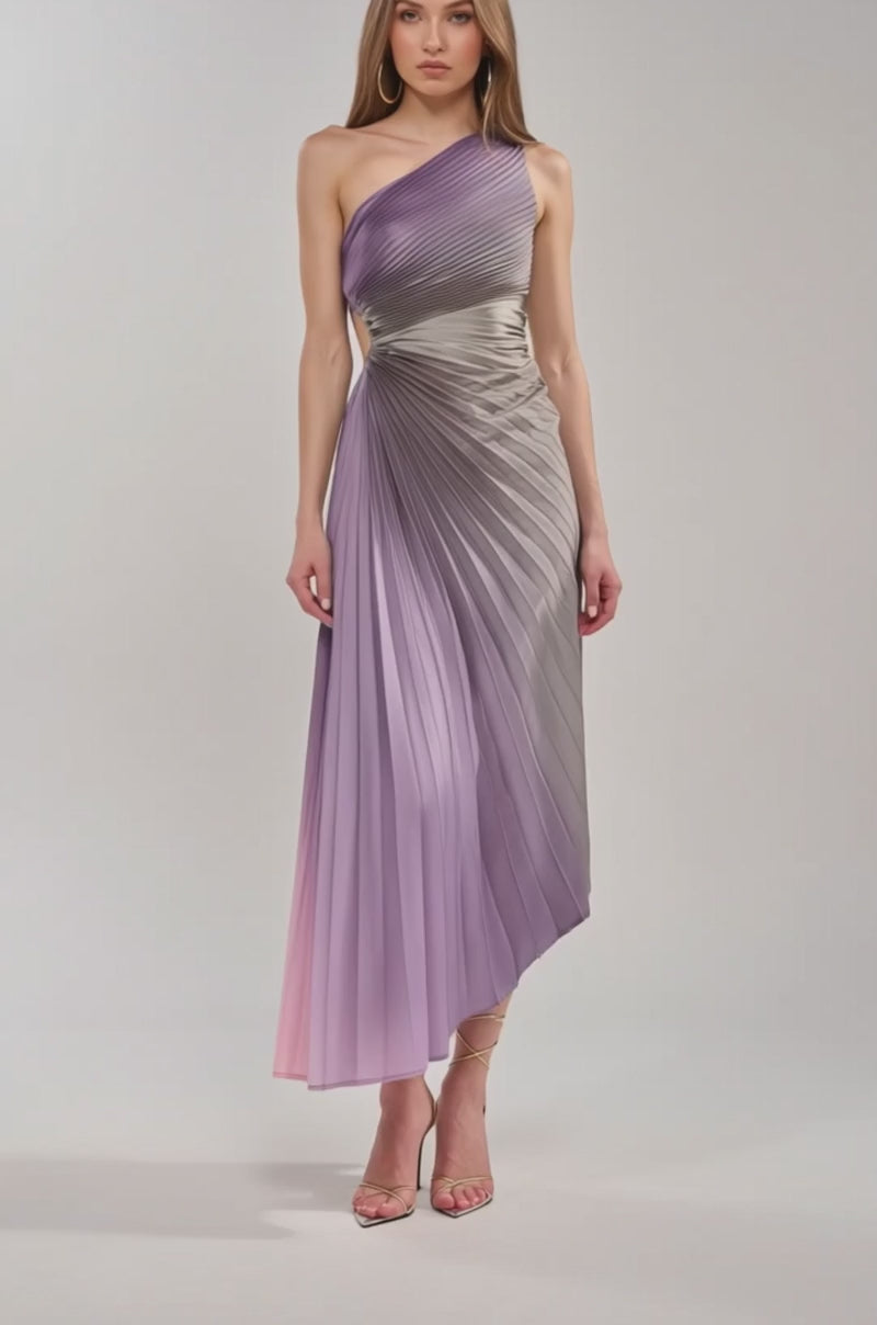 Video of woman modeling the HERE TO SHINE PURPLE MAXI DRESS, an ombré one-shoulder pleated dress in gradient purple and pink, styled with strappy high-heeled sandals.