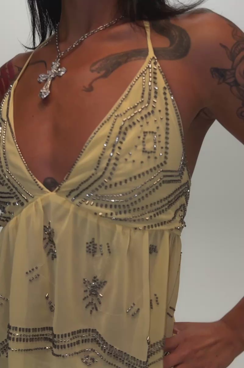 Video of a woman modeling the 90′S BEADED CHIFFON TOP IN YELLOW.