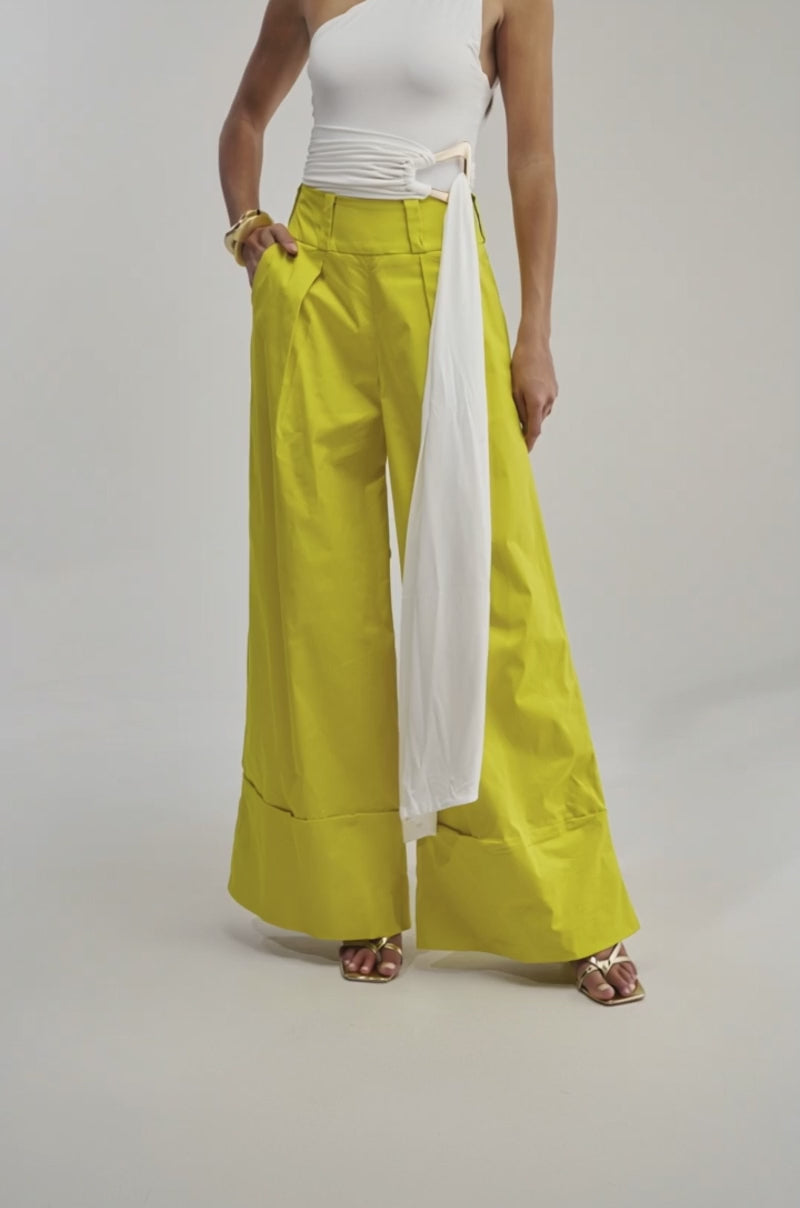 A video of a model wearing the GIVE IT TO ME BABY TROUSER with a white one-shoulder top with a long sash, showcasing funky style.