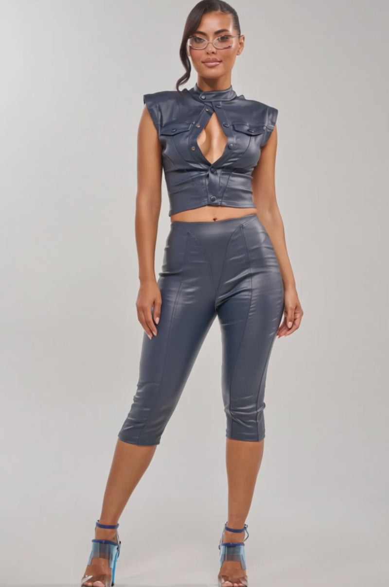 Video of woman modeling the BIG CITY LIVIN FAUX LEATHER BUTTON DOWN, a shiny dark blue top paired with matching high-waisted pants