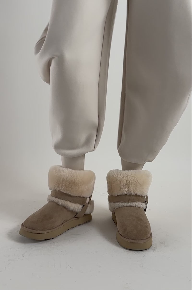 Video of a woman modeling the AZALEA WANG BRILLE TAUPE SHEARLING FLAT BOOTIE.