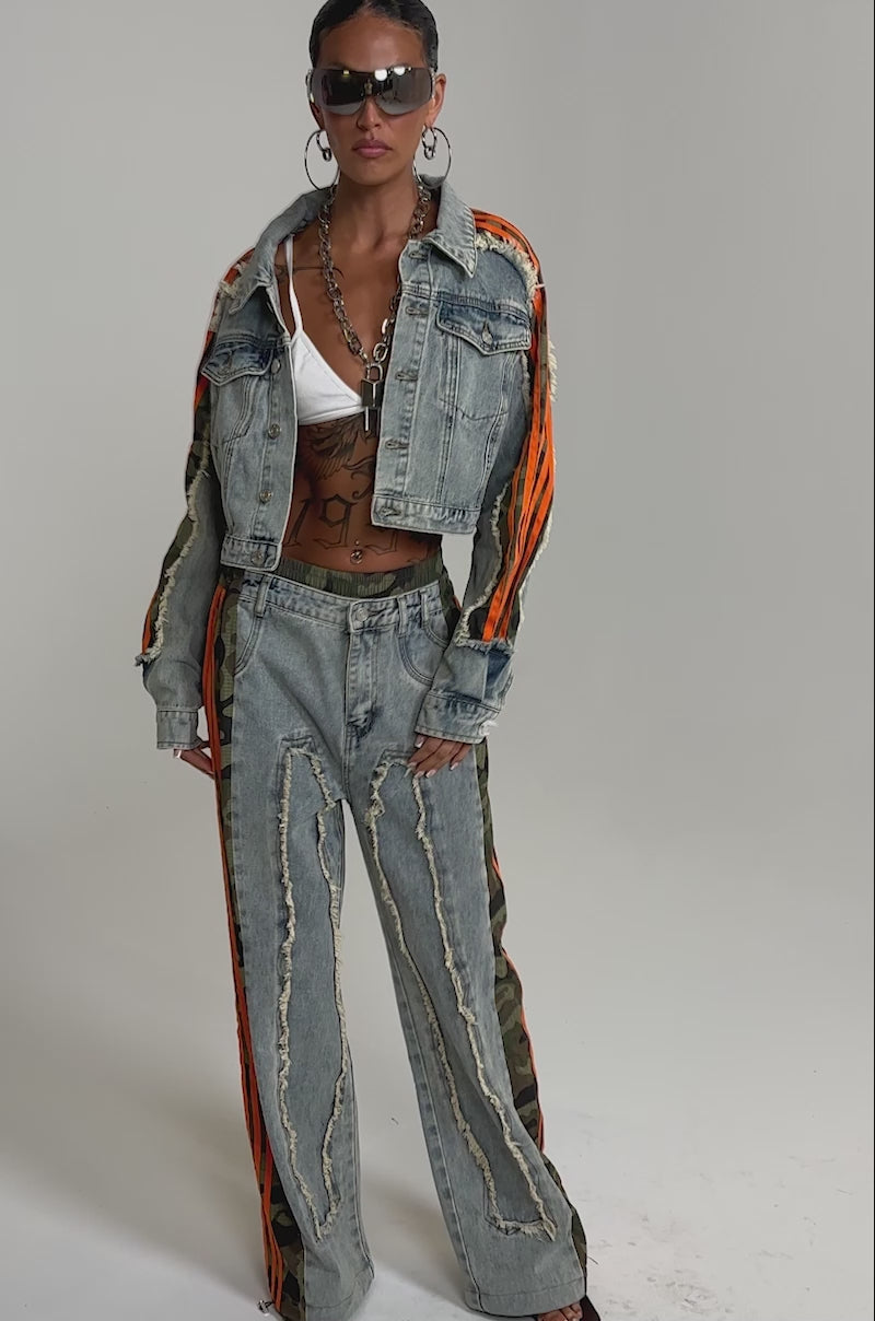A video of a person wearing sunglasses poses in the ALL AROUND THE WORLD AGAIN JACKET IN LIGHT BLUE DENIM, styled with distressed jeans.